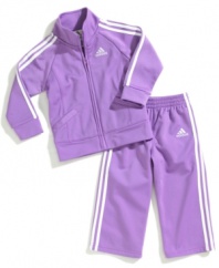 Her sporty style will really stand out in this colorful tricot jacket and pant set from adidas.