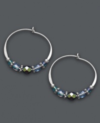 Multi-faceted style. Jody Coyote's unique hoop earrings get an updated look with the addition of faceted blue glass beads, seed beads, sterling silver beads and antique silver plated pewter beads. Set in sterling silver. Approximate diameter: 7/8 inch.
