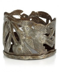 Cut, hammered and varnished by artist Michaelson, this metal candle holder accompanies flickering candlelight with intricate birds and branches. Steel from recycled barrels gives each one-of-a-kind piece a rustic beauty perfected by Haiti's esteemed artisans.
