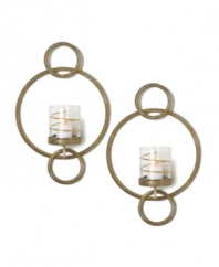 Equal parts wall art and lighting solution, each Symphony Ring sconce by Mikasa glows with whimsical splendor. Featuring rings of goldtone metal and glass candle holders wrapped in shimmering ribbons.