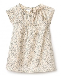 Cap sleeve dress with a vintage appeal, rendered in a soft beige base with muted floral prints. The crewneck and sleeves are gathered, while the hem is pleated and flowing.
