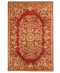 Rich in both tone and tradition, this exquisite Safavieh area rug creates a unforgettable focal point with a vine-and-blossom motif that coils beautifully against a striking red background. Tufted in India from pure wool, this rug adds incredible allure to any space. (Clearance)