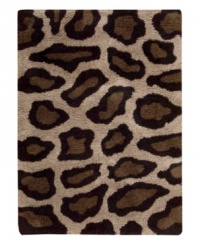Exotic designs will be the pride of your decor. Adorned with leopard spots in beige and black, this Nourison rug has a marvelously soft and shaggy pile that's hand-tufted from premium-quality yarns. Beautiful in appearance and plush underfoot, this area rug creates an atmosphere of casual elegance.