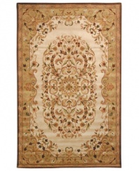Traditionally inspired elegance. With an ornate motif in soft beige and green hues, Safavieh's Heritage rug takes any room from attractive to stunning in moments. Hand-tufted of pure wool with strong cotton backing, the rug can withstand even the most highly traveled areas of your home. (Clearance)