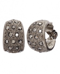 Distinctive and dazzling! Monet dresses up traditional hoop earrings with sparkling marcasite. Set in silver tone mixed metal, they'll shine brightly whenever you wear them. Approximate diameter: 5/8 inch.