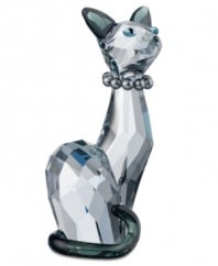 Ines, Swarovski's high-fashion feline, sits tall and proud in faceted shadow crystal. A string of gray pearls and contrasting ears and tail emphasize her slender physique and ladylike pose.
