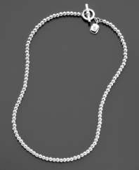 This silvertone ball necklace (4 mm) from Lauren Ralph Lauren with a cute logo charm is the perfect accessory for day or night. Toggle closure. Length measures 16 inches.