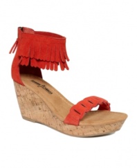Moccasins get a summer makeover. The Nicki sandals by Minnetonka reinterpret the classic wedge with a fringed ankle wrap.
