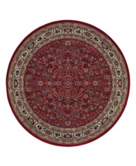 Inspired by the lovely Sarouk carpets of ancient Persia, this round rug features an intricate floral motif in ivory, sage green and accents of soft blue against a rich red ground.