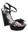 Pretty prints stacked tall make the cutest sandals. Bebe's Florenza platform wedge sandals feature a black patent bow on the toe and matching ankle strap.