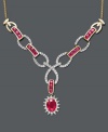 Turn heads with dazzling color and spectacular design. Necklace features oval and round-cut rubies (2 ct. t.w.) and interlocking links decorated in sparkling diamonds (1/2 ct. t.w.). Toggle style necklace crafted in 14k gold. Approximate length: 18 inches. Approximate drop: 2-1/2 inches.