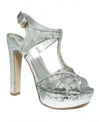 Viva glam! The Indrina platform sandals by GUESS are decked out with glittery shimmer and metallic shine. The super-high heel and platform add lift to your already dazzling look.