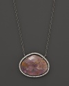 Diamonds circle a faceted rutilated quartz and purple charoite doublet set in blackened sterling silver. By Di Massima.