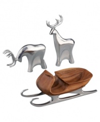 Add artisinal craftsmanship to your home this holiday with this set of two grazing reindeer and sleigh, crafted of lustrous  Nambé alloy and acacia wood. Designed by Todd Myers. The tallest reindeer stands 9-1/2 high. Both reindeer are 4 wide. The sleigh measures 11-1/2 x 3-1/4.