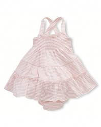 A comfortable striped cotton dress is fashioned with smocked detailing and a full ruffled skirt for girlie style.