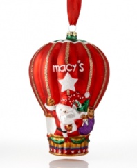 Santa and friends wave hello-ho-ho from the macy's hot air balloon. In gleaming red with gold glitter and Christmas garland, this whimsical ornament takes your tree to festive new heights.