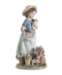 The picture of happiness. Lladro's A Romp in the Garden figurine features cute puppies, spring flowers and the sweet woman who takes care of them all in delicately glazed porcelain.