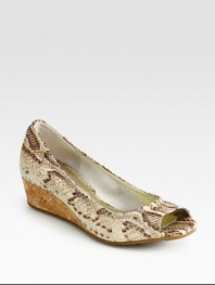 Divine snake print adds dimension to this leather wedge with high-tech cushioning and a natural cork wedge. Cork wedge, 1 (25mm)Snake-print leather upperLeather liningRubber solePadded insoleImported