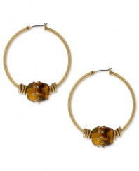 Trendy tortoise helps you break out of your shell. These natural-chic hoops from Kenneth Cole New York feature tortoise resin beads embellished with pave crystals. Crafted in gold tone mixed metal. Approximate drop: 1-3/4 inches. Approximate diameter: 1-1/2 inches.