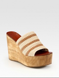 Artfully crafted woven leather upper joined by an earthy wooden wedge and platform. Wooden wedge, 4 (100mm)Wooden platform, 2 (50mm)Compares to a 2 heel (50mm)Woven leather upperLeather liningRubber soleImported