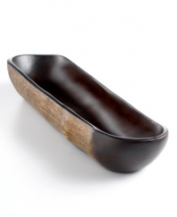 Hand-carved from a branch of the fast-growing obeche tree, this rustic boat bowl is an ode to the Haitian mountainside and designed by Haiti's master woodwork artist, Einstein Albert. A unique vessel for displaying cool objects, fake fruit or simply accenting the table.
