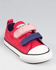 Cute color comes to Converse with this sneaker featuring easy-on, easy-off velcro straps and contrast piping.
