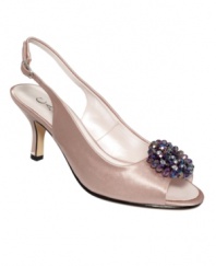 A satin sensation. Exude poise and polish with the Zurina evening pumps by Caparros, featuring a slingback design and beaded floral brooch accent.