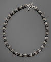 Sultry black onyx beads (8.5-9mm) swathed in sterling silver and 14k gold accents give your neckline glitter. Necklace measures 18.