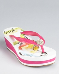Juicy Couture's Iris wedge sandal features a rhinestone detail at the strap and a parrot print on the padded footbed.
