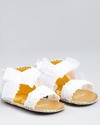 Wide eyelet ribbons and an oversized bow add a dreamy touch to these irresistible sandals from Juicy Couture.