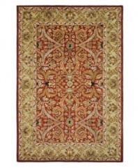 A luxurious arrangement of swirling florals gives this Safavieh area rug a decidedly classical appeal. Tufted in India from pure wool, this rug boasts a background of deep red and a supporting palette of color that creates a beautiful contrast of light and dark. (Clearance)