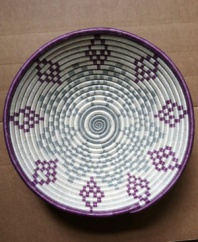 A reminder of Rwanda's past but also its potential, this beautiful hand-woven basket is a symbol of strength, any way you look at it. The geometric pattern, inspired by complex African gemstones, pops with elements of rich purple, slate blue and natural ivory.
