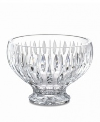 A series of vertical wedge cuts around the side of this lead crystal bowl create an effect of subtle radiance. Measuring 8 in diameter with a dramatic raised base.