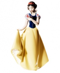 The fairest in the land, this Snow White figurine is nothing short of 12 dwarves. Stopping to smell the flowers, she's epitome of Disney princesses in handmade porcelain from Nao by Lladro.
