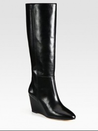With intricate stitching and a glossy finish, this leather knee-high design has a towering wedge and padded insole. Self-covered wedge, 3 (75mm)Shaft, 15½Leg circumference, 14Leather upperLeather lining and solePadded insoleImported