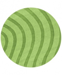 Abstract and absorbing, this unique rug adds movement to any room. Playful, wavy lines reverberate against a forest-green ground, resounding with personality in your home.