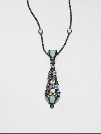 A colorful pendant encrusted with faceted multi-colored sapphires and blue topaz stones accented with bright enamel on a blue topaz station necklace on a rhodium-plated sterling silver link chain. Blue topazMulti-colored sapphiresEnamelRhodium-plated sterling silverLength, about 16Pendant size, about 2Lobster claspImported 