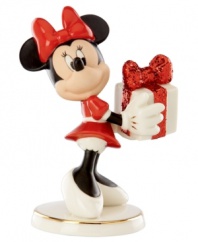 What a gift! A very beautiful Minnie Mouse delivers a sparkle-wrapped surprise for someone special in this magical Disney figurine by Lenox.