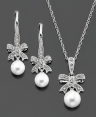 Dazzling bows with diamond accents are the perfect accompaniment to smooth cultured freshwater pearls (6-7.5 mm) on this matching pendant and earrings set in sterling silver. Pendant measures approximately 18 inches with a 1-inch drop. Earrings measure approximately 1 inch.
