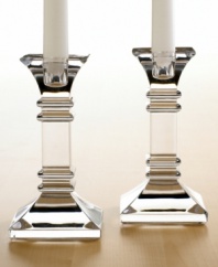 A modern take on a classic design, these crystal candlesticks feature sleek lines and sharp, precise edges that converge on a substantial base. In clear lead crystal.