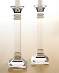 A modern take on a classic design, these crystal candlesticks feature sleek lines and sharp, precise edges that converge on a substantial base. In clear lead crystal.