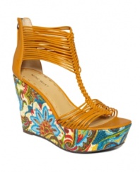 Get in an island state of mind. The Lightenup sandals by Nine West burst with floral color at the sky-high wedge, while the unique strap design stuns onlookers.