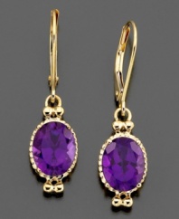 Dress up with regal beauty. These magnificent earrings feature oval-cut amethyst (3-1/4 ct. t.w.) set in 14k gold. Approximate drop: