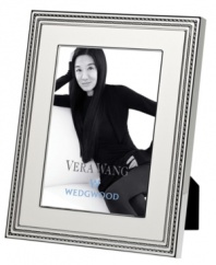 Add new elegance to beautiful memories with Vera Wang's With Love Blanc picture frame. Geometric detail lends metallic shimmer to creamy white enamel in a home accent that invokes modern and deco design.