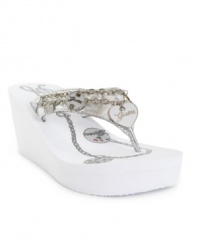 The Guess Seren Sandals are charming with their fun logo and chain embellishments on a breezy flip flop wedge.