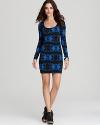 Embody beauty-and-the-beach style in this Volcom knit dress, cut in a body-con silhouette and boasting a bold blue and black print. Edgy booties complete with surf-inspired attitude.
