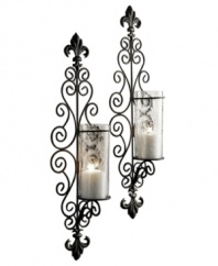 Spark drama in your foyer or living room with the Della Corte candle sconce set. Extravagant swirls of black metal capped with double fleur de lys lend modern-day romance to vintage-inspired decor.