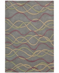 Graphic appeal: an abstract, wavy design flows across the silver field of Nourison's mesmerizing City Limits rug, giving any room a sense of urban-inspired chic. Hand-tufted of polyacrylic fibers, the rug is pleasingly soft, textured and easy to clean.