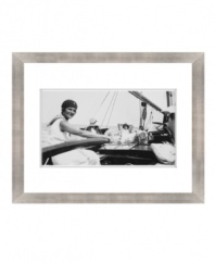 From working the rudder to lounging in the sun, this vintage art print shows the many sides of sailing in classic black and white. Matted and framed with a breezy sensibility for seaside homes.