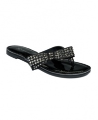 A glittering side bow adds pizazz to the Giselle flat thong sandals by INC International Concepts.